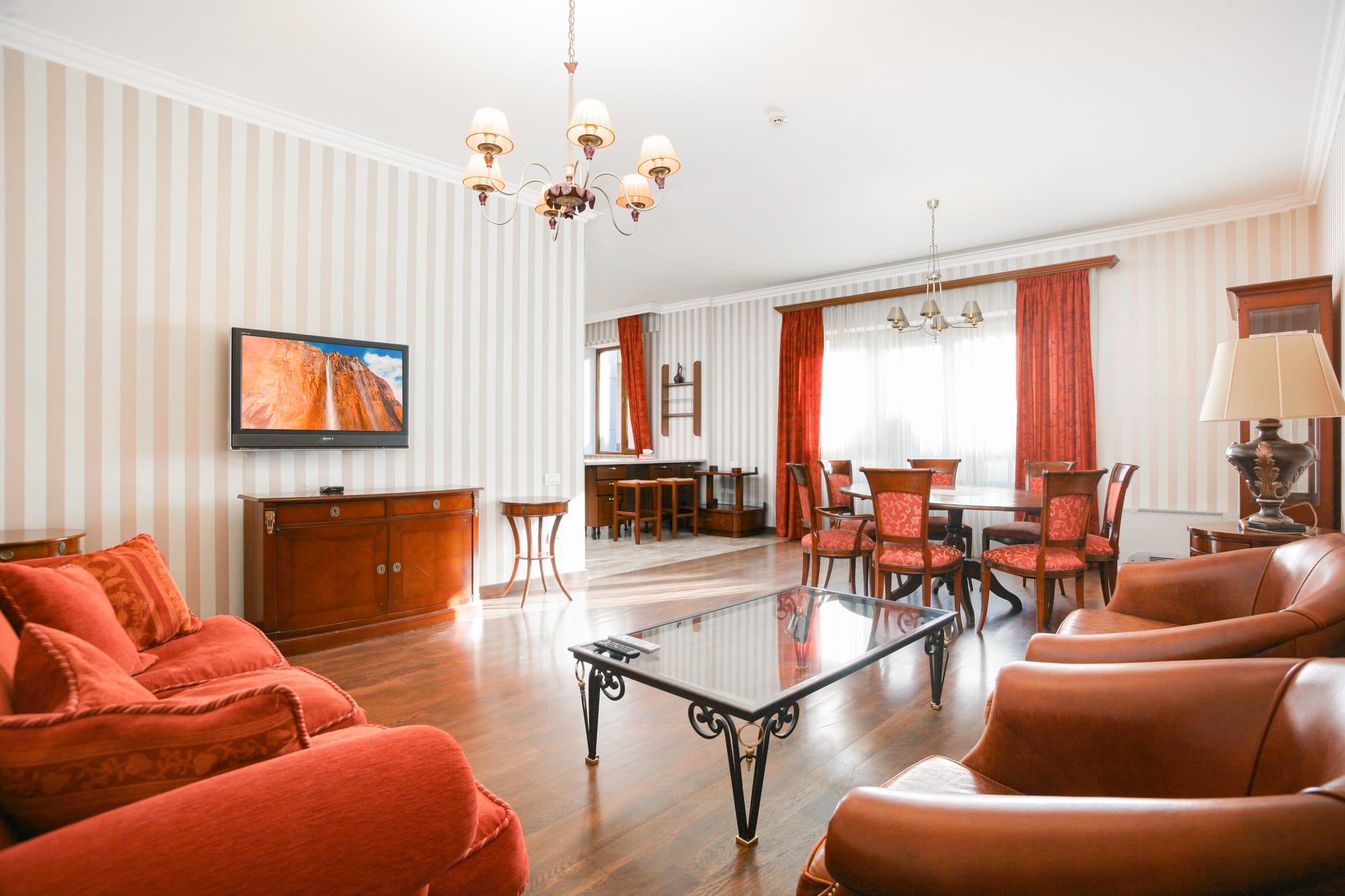 Living room photographed from the corner, showing the dining area beyond